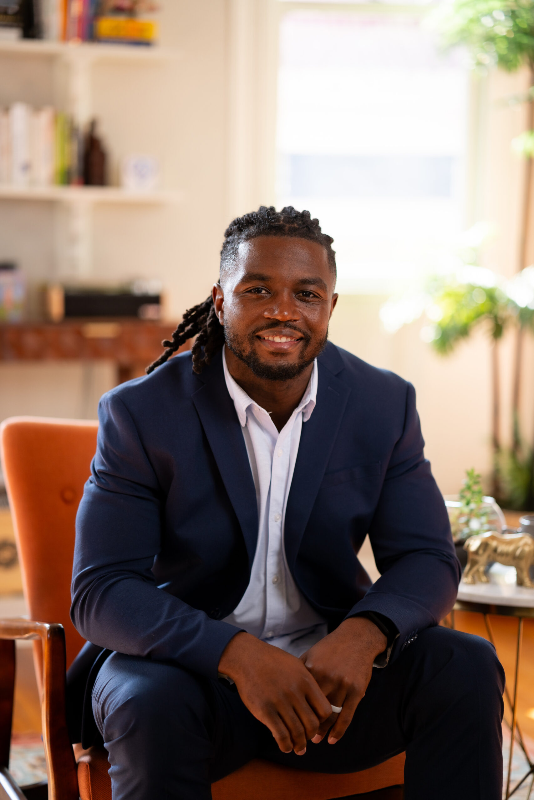 Brandon Wilson, Financial Advisor at WFA sitting in a chair in the office