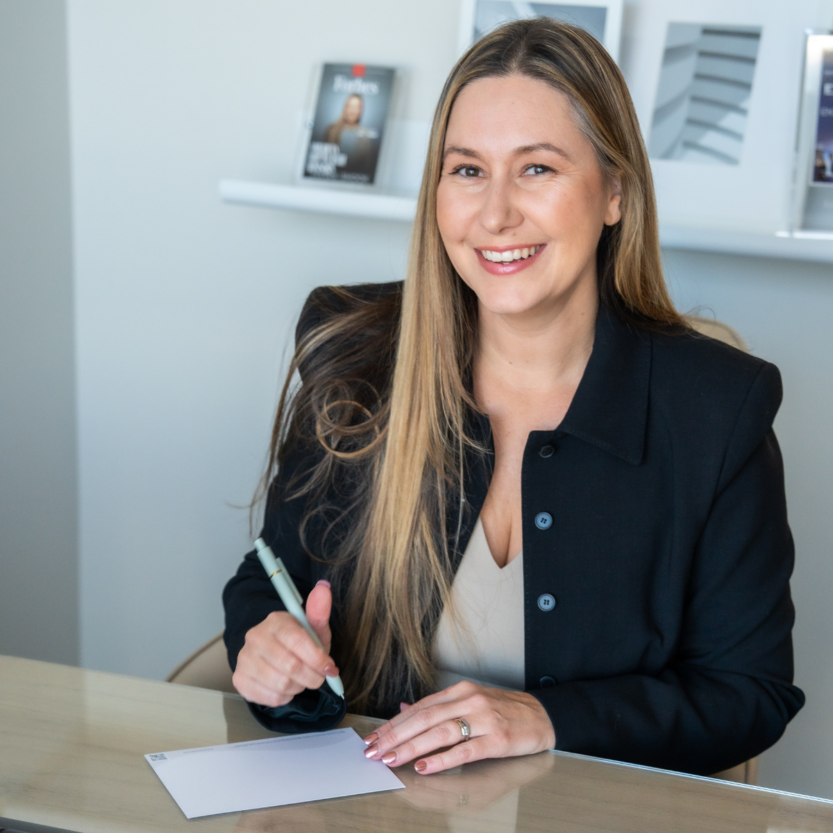 Financial Advisor sitting at her desk writing on stationary.